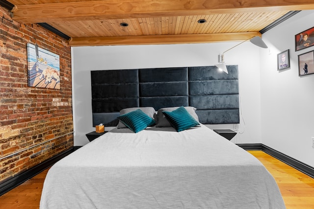 bedroom with hardwood / wood-style floors, wooden ceiling, beamed ceiling, and brick wall