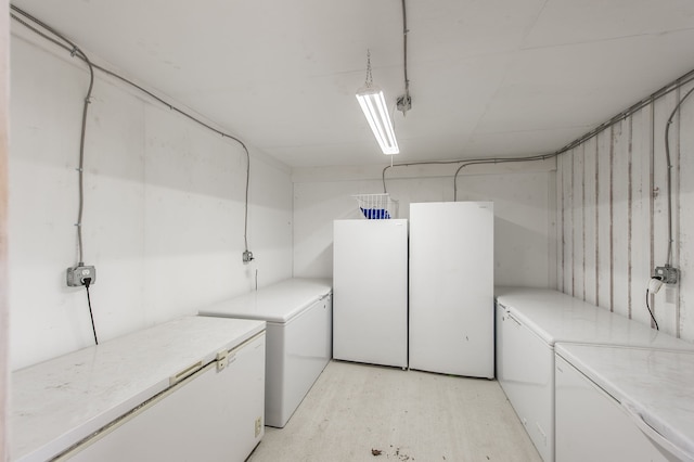 clothes washing area featuring separate washer and dryer