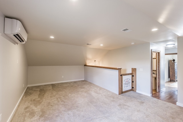 interior space with an AC wall unit, light carpet, and lofted ceiling