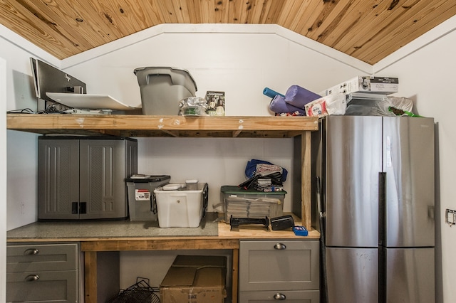 kitchen with stainless steel refrigerator, wood ceiling, and lofted ceiling