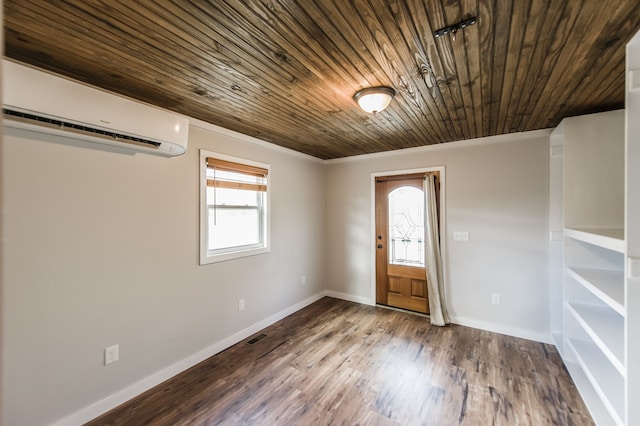 empty room featuring hardwood / wood-style flooring, an AC wall unit, crown molding, and wooden ceiling