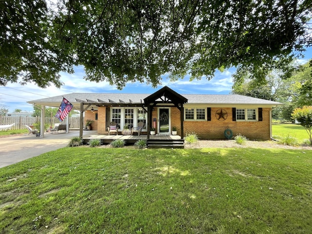 ranch-style house featuring a deck and a front lawn