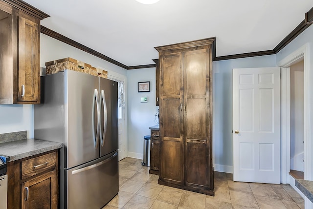 kitchen with stainless steel refrigerator and ornamental molding