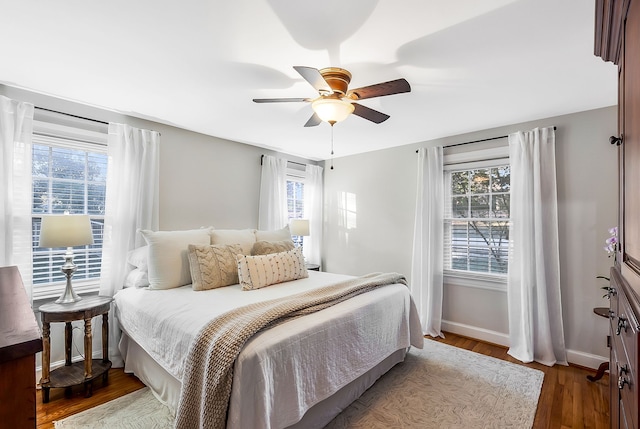 bedroom with ceiling fan and dark hardwood / wood-style flooring