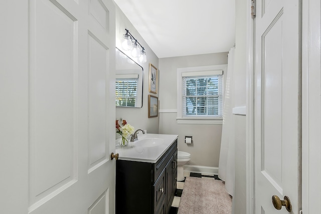 bathroom featuring vanity and toilet