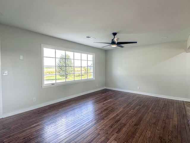 unfurnished room with ceiling fan and dark hardwood / wood-style floors