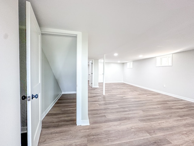 basement with light hardwood / wood-style floors