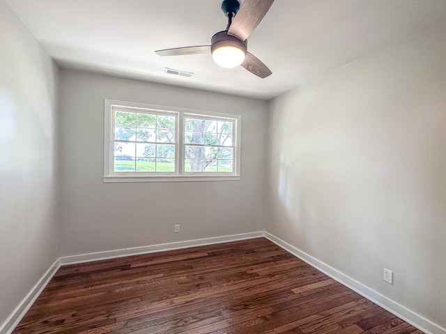 empty room with ceiling fan and dark hardwood / wood-style floors