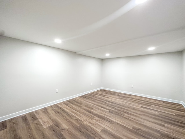 spare room featuring wood-type flooring