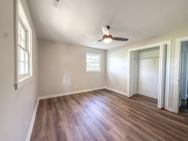 unfurnished bedroom featuring a closet, ceiling fan, and dark hardwood / wood-style flooring