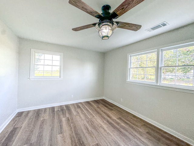 empty room featuring wood-type flooring and ceiling fan