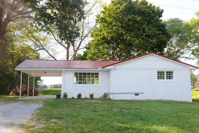 view of front of property with a front yard and a carport