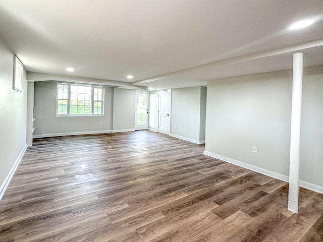 basement with dark hardwood / wood-style floors