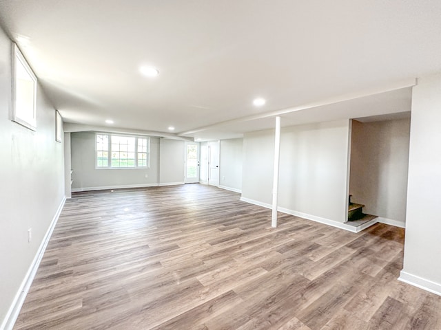 basement with light hardwood / wood-style floors