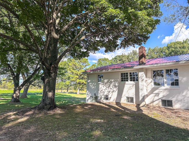 view of side of home with a yard and cooling unit