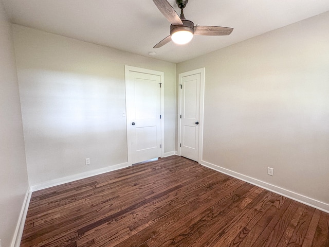 unfurnished room featuring ceiling fan and dark hardwood / wood-style flooring