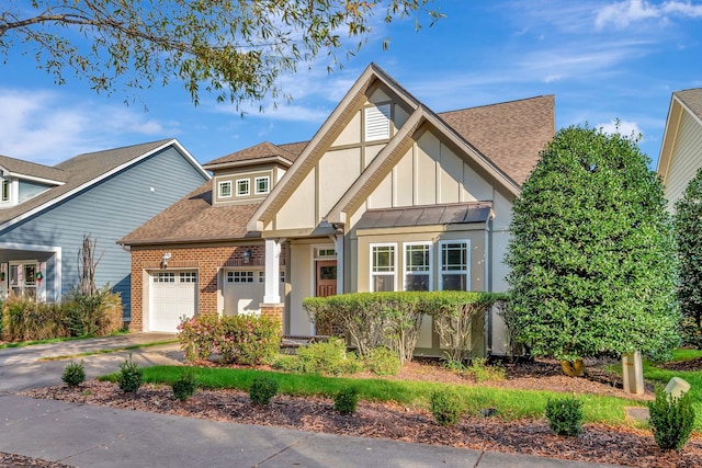 english style home featuring a garage