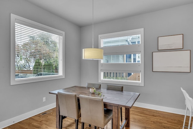 dining space with hardwood / wood-style flooring