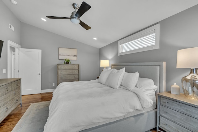 bedroom featuring ceiling fan, dark hardwood / wood-style flooring, and lofted ceiling