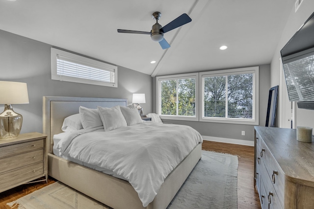 bedroom featuring ceiling fan, hardwood / wood-style floors, and vaulted ceiling