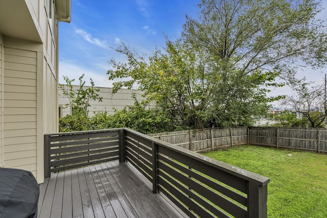 wooden terrace with a lawn