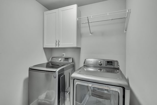 laundry area featuring cabinets and washer and dryer