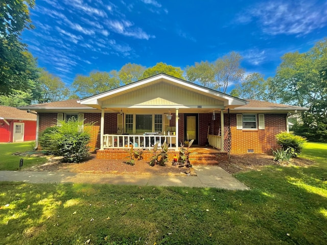 ranch-style home featuring a front yard and a porch