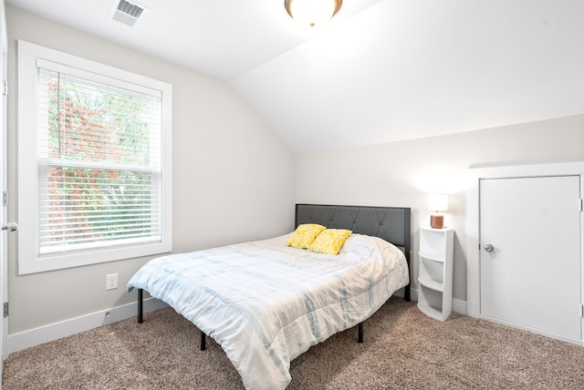 bedroom featuring carpet floors and lofted ceiling