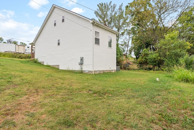 view of side of property with a lawn