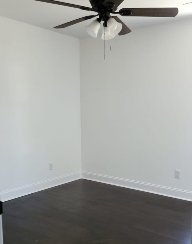 empty room featuring ceiling fan and dark hardwood / wood-style flooring