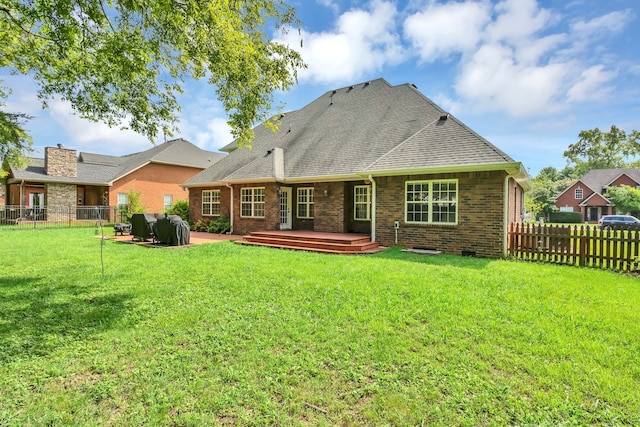 rear view of house with a deck, a yard, and a patio