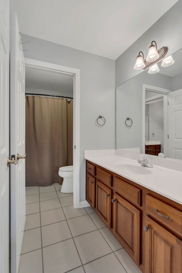 bathroom featuring toilet, vanity, and tile patterned floors