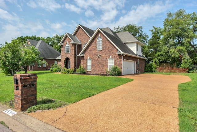 view of front of home with a front yard and a garage