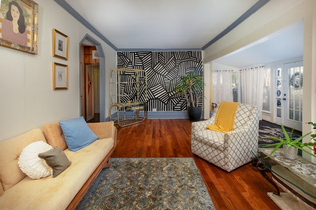 living room with dark hardwood / wood-style flooring and ornamental molding