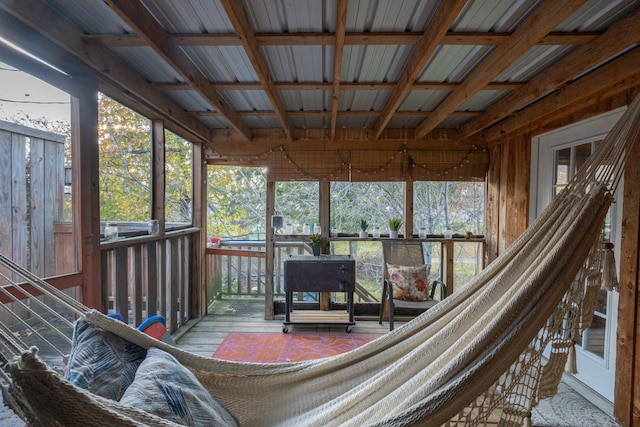 sunroom / solarium with plenty of natural light, beam ceiling, and coffered ceiling