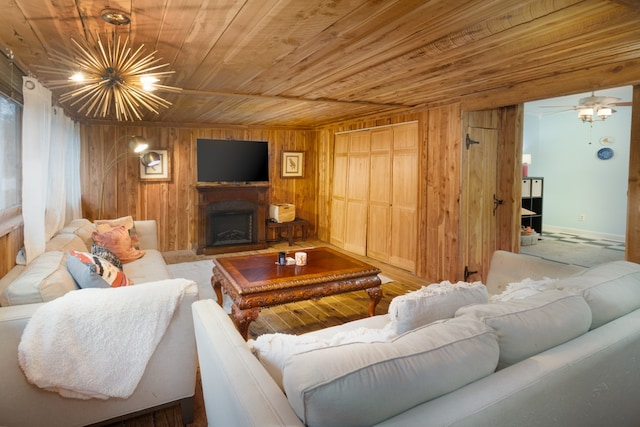 living room with wooden walls, ceiling fan, and wood ceiling