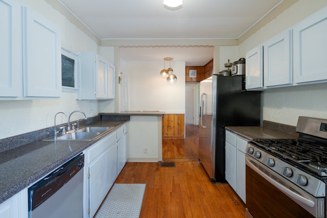 kitchen featuring light hardwood / wood-style flooring, white cabinets, stainless steel appliances, and sink