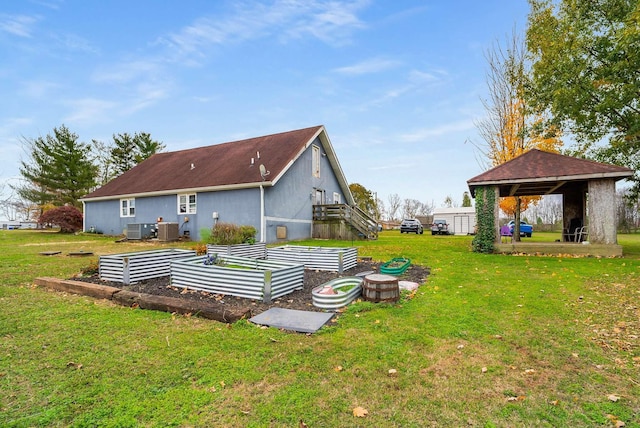 back of house with a lawn and cooling unit