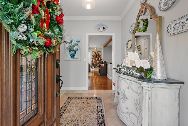 tiled entryway featuring crown molding