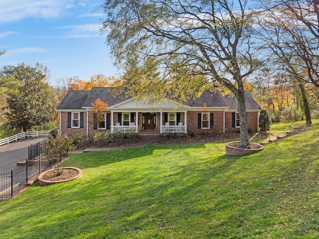 ranch-style house with covered porch and a front yard