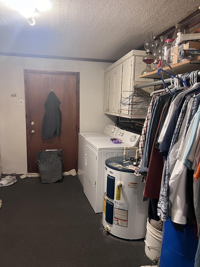 laundry room with cabinets, a textured ceiling, electric water heater, and washing machine and clothes dryer