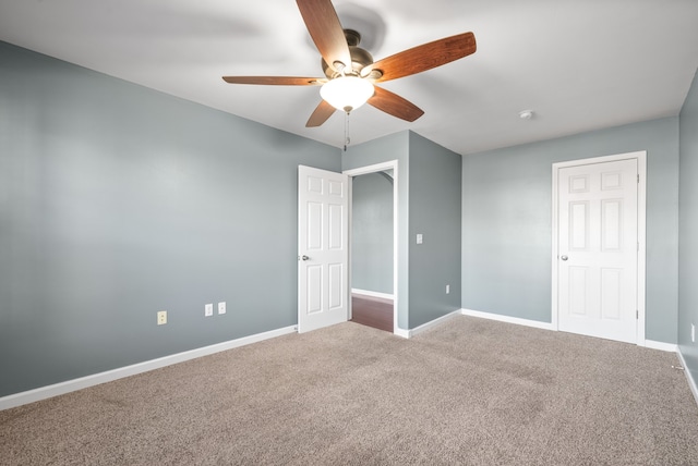 unfurnished room with ceiling fan and carpet