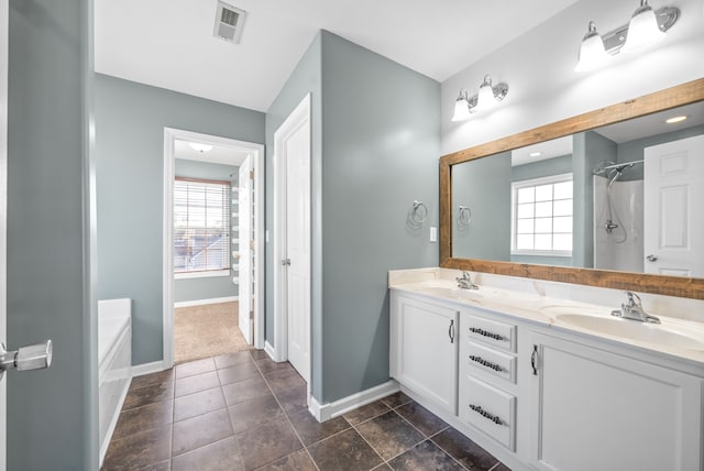 bathroom featuring vanity and a washtub