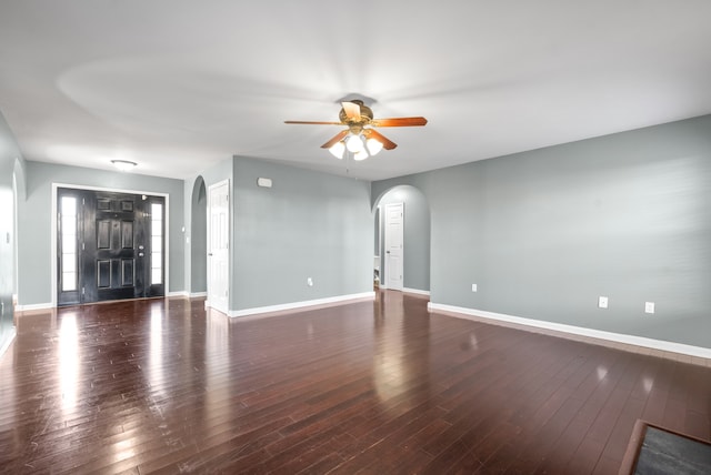 interior space with ceiling fan and dark hardwood / wood-style flooring