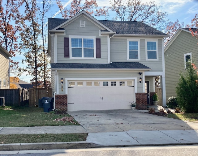 view of front of property with a garage and a front lawn