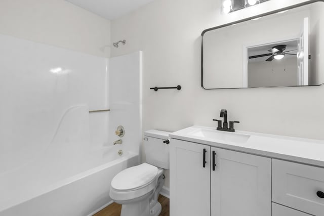 full bathroom with ceiling fan,  shower combination, toilet, and vanity