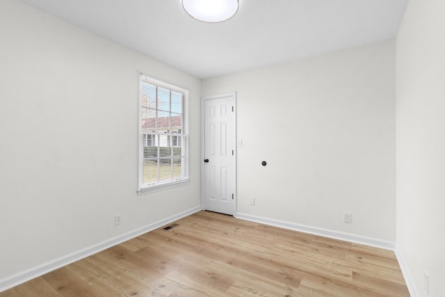 spare room featuring light wood-type flooring