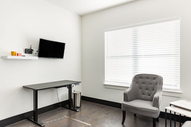 sitting room with baseboards and dark wood-style flooring