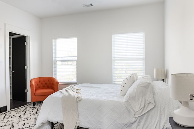 bedroom featuring visible vents and wood finished floors