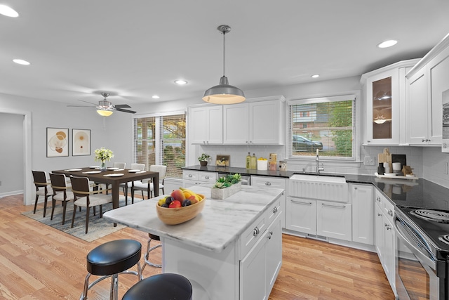 kitchen featuring pendant lighting, light hardwood / wood-style flooring, and a wealth of natural light